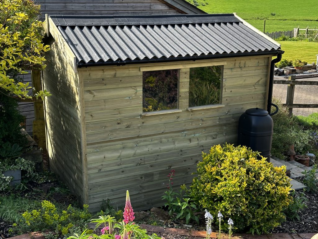 8x6 garden shed with onduline roofing and guttering, apex roof and the windows on the side